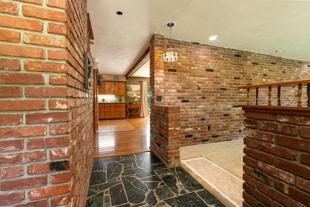 424 W Olive St, Bolivar, MO 65613 - corridor featuring brick wall, stone floors, and recessed lighting