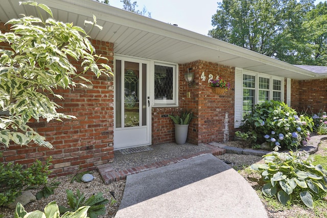 424 W Olive St, Bolivar, MO 65613 - doorway to property featuring brick siding
