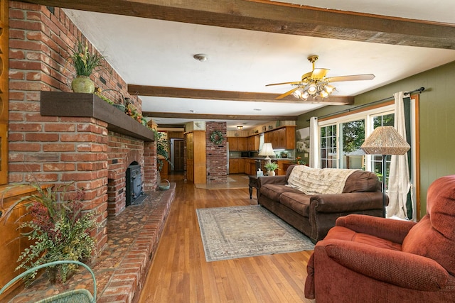 424 W Olive St, Bolivar, MO 65613 - living area with beamed ceiling, light wood-style floors, ceiling fan, and a brick fireplace