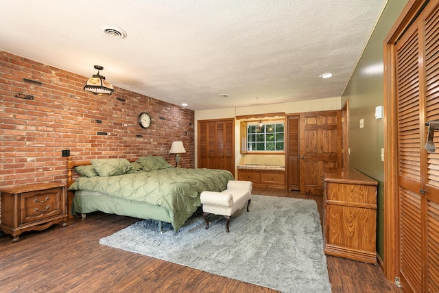 424 W Olive St, Bolivar, MO 65613 - bedroom featuring dark wood-style floors, brick wall, and recessed lighting