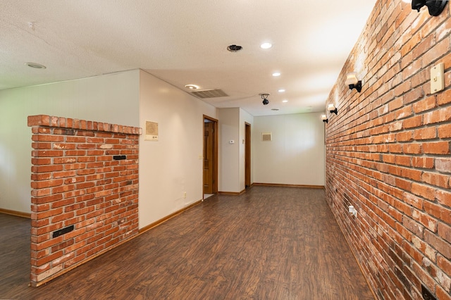 424 W Olive St, Bolivar, MO 65613 - spare room with brick wall, wood finished floors, and recessed lighting