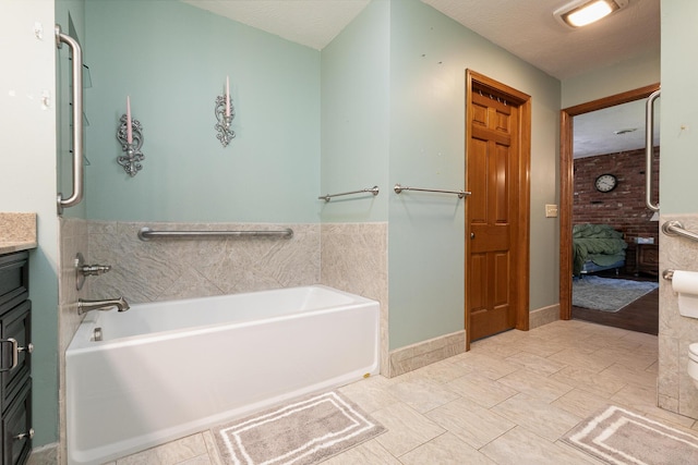 424 W Olive St, Bolivar, MO 65613 - full bath featuring a garden tub, ensuite bath, vanity, and wainscoting
