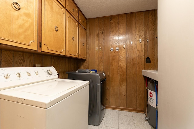 424 W Olive St, Bolivar, MO 65613 - washroom featuring cabinet space, separate washer and dryer, wooden walls, and a textured ceiling