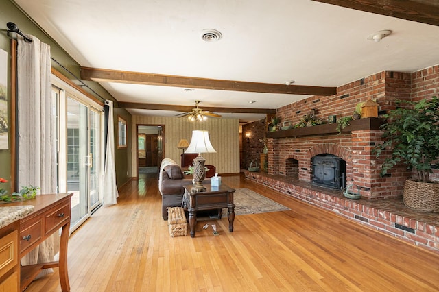 424 W Olive St, Bolivar, MO 65613 - living room featuring light wood-style floors, beamed ceiling, a ceiling fan, and brick wall