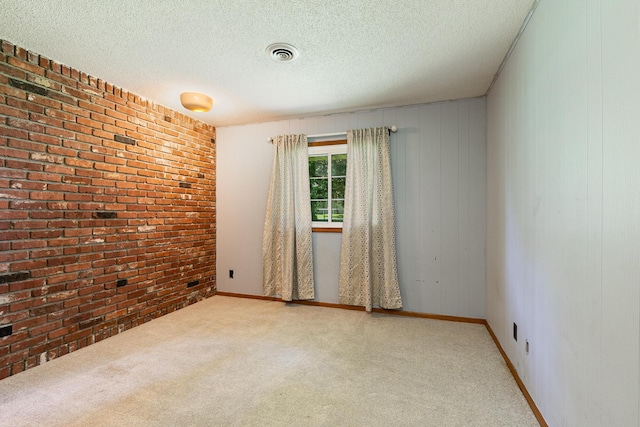 424 W Olive St, Bolivar, MO 65613 - unfurnished room featuring brick wall, carpet flooring, and a textured ceiling