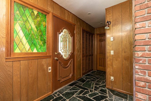 424 W Olive St, Bolivar, MO 65613 - entrance foyer with stone flooring and wood walls