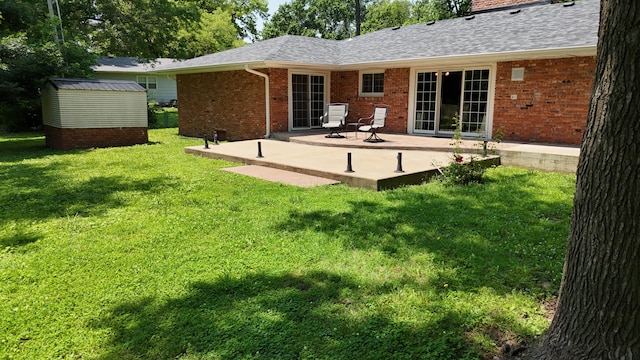 424 W Olive St, Bolivar, MO 65613 - rear view of property featuring a patio area, brick siding, a chimney, a storage shed, and a lawn