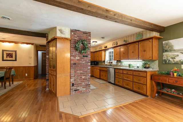 424 W Olive St, Bolivar, MO 65613 - kitchen featuring stainless steel dishwasher, beamed ceiling, light wood-style floors, brown cabinetry, and wood walls