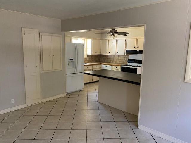 2166 S Lone Pine Ave, Springfield, MO 65804 - kitchen with white appliances, under cabinet range hood, ceiling fan, decorative backsplash, and white cabinets