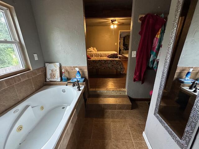 3200 Driftwood Rd, Merriam Woods, MO 65740 - ensuite bathroom featuring a whirlpool tub, tile patterned floors, and a ceiling fan