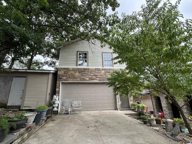 3200 Driftwood Rd, Merriam Woods, MO 65740 - view of front of house featuring stone siding, an attached garage, and concrete driveway