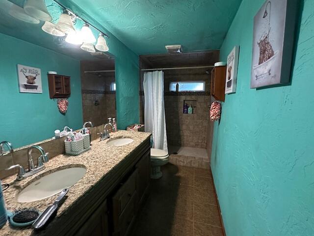 3200 Driftwood Rd, Merriam Woods, MO 65740 - bathroom with a tile shower, double vanity, and tile patterned floors
