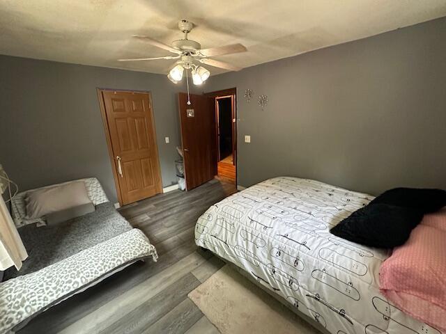 3200 Driftwood Rd, Merriam Woods, MO 65740 - bedroom with dark wood finished floors and ceiling fan