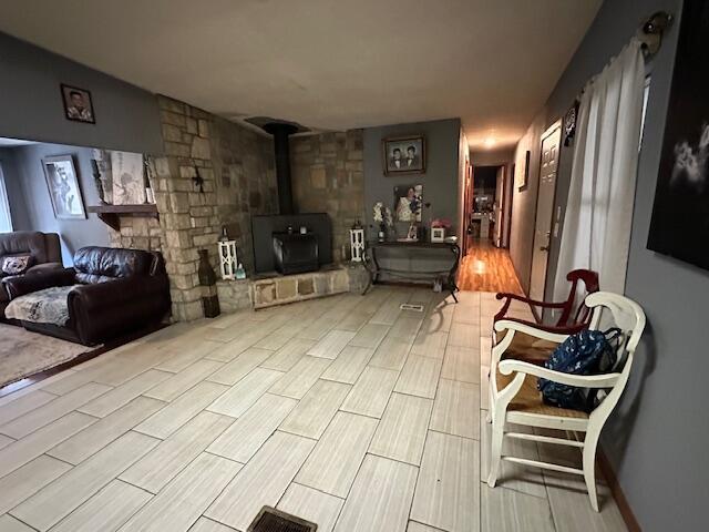 3200 Driftwood Rd, Merriam Woods, MO 65740 - living area with a wood stove and wood finished floors