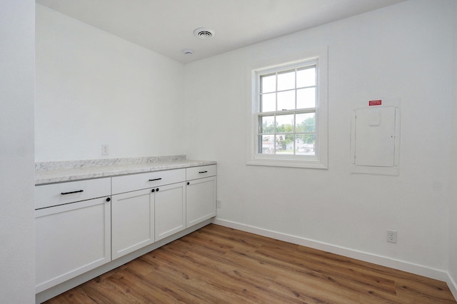119 E Mill St, Republic, MO 65738 - unfurnished room featuring electric panel and light wood-type flooring