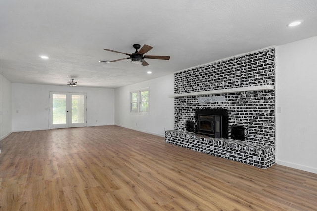 119 E Mill St, Republic, MO 65738 - unfurnished living room with a ceiling fan, wood finished floors, recessed lighting, a wood stove, and french doors