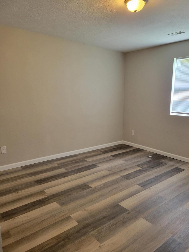809 Elm Ave, Ava, MO 65608 - unfurnished room with dark wood-style flooring and baseboards