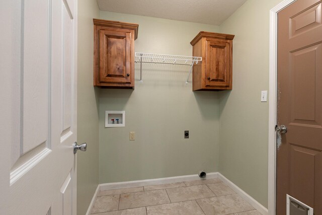 942 E Ozark Jubilee Dr, Nixa, MO 65714 - laundry area with electric dryer hookup, hookup for a washing machine, cabinet space, and light tile patterned floors