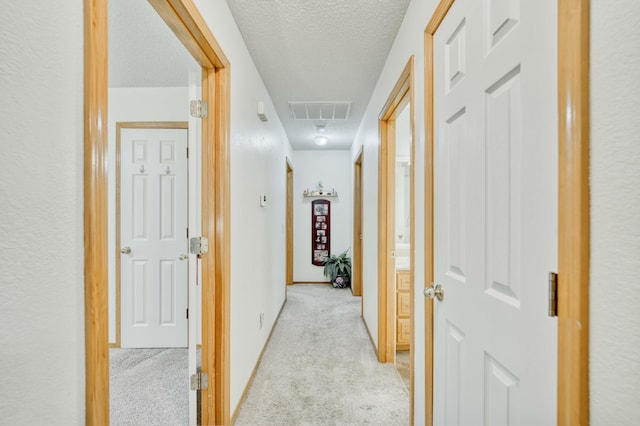 202 N Harper Ave, Springfield, MO 65802 - corridor featuring a textured ceiling, light colored carpet, and attic access