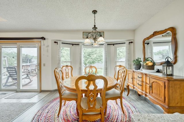 202 N Harper Ave, Springfield, MO 65802 - dining space featuring a textured ceiling, a chandelier, and light wood-type flooring