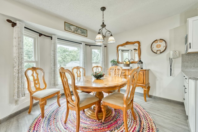202 N Harper Ave, Springfield, MO 65802 - dining room featuring light wood-type flooring and a textured ceiling