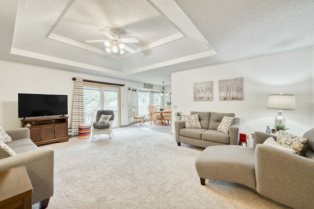 202 N Harper Ave, Springfield, MO 65802 - carpeted living area featuring a raised ceiling, a textured ceiling, and ceiling fan