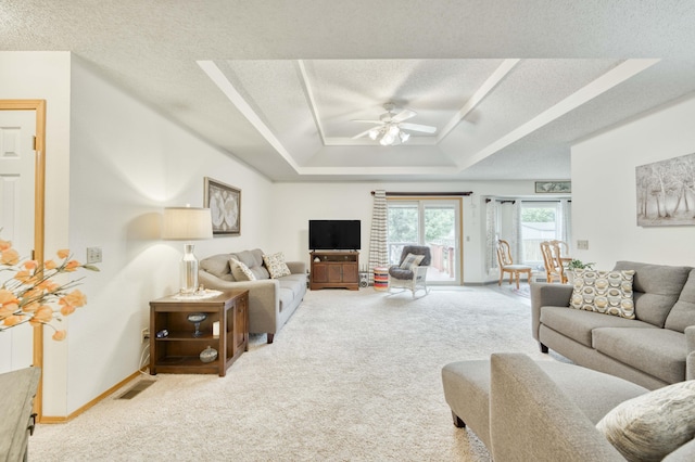 202 N Harper Ave, Springfield, MO 65802 - carpeted living room featuring a textured ceiling, a ceiling fan, and a raised ceiling