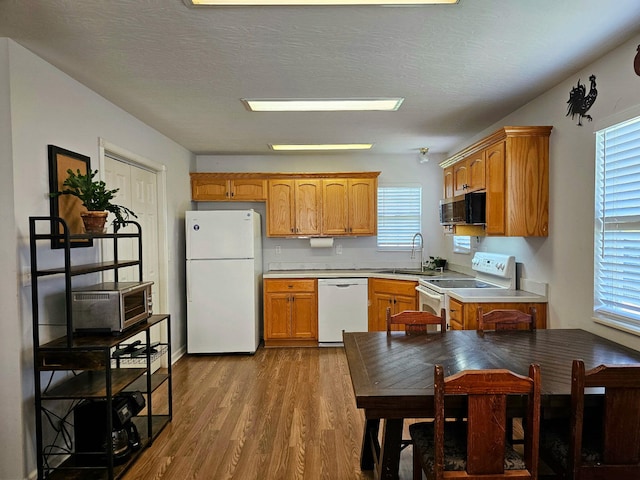 551 State Highway O, Seymour, MO 65746 - kitchen with white appliances, wood finished floors, light countertops, and brown cabinets