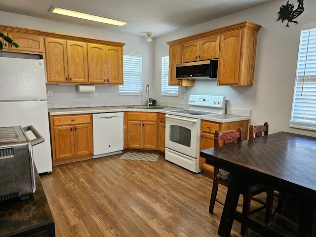 551 State Highway O, Seymour, MO 65746 - kitchen featuring white appliances, light countertops, wood finished floors, and plenty of natural light