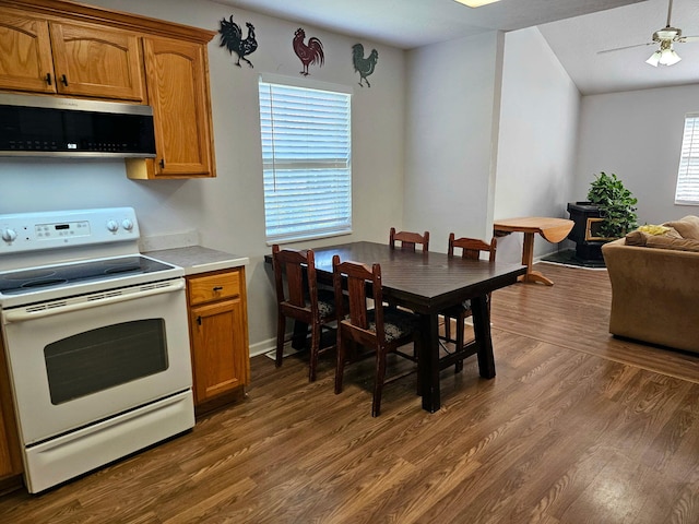 551 State Highway O, Seymour, MO 65746 - kitchen featuring white electric range oven, stainless steel microwave, dark wood-style flooring, and light countertops