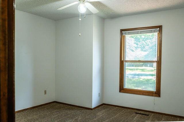 2812 W Maplewood St, Springfield, MO 65807 - spare room with a textured ceiling, ceiling fan, and carpet flooring