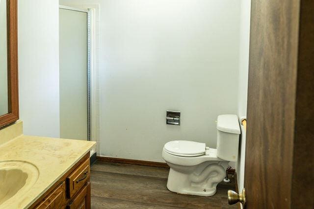 2812 W Maplewood St, Springfield, MO 65807 - full bath featuring wood finished floors, vanity, and an enclosed shower