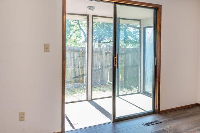 2812 W Maplewood St, Springfield, MO 65807 - doorway to outside featuring wood finished floors and baseboards