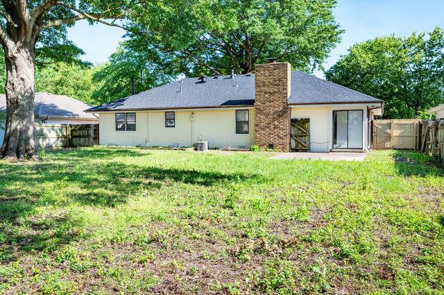 2812 W Maplewood St, Springfield, MO 65807 - rear view of property featuring a chimney and a fenced backyard