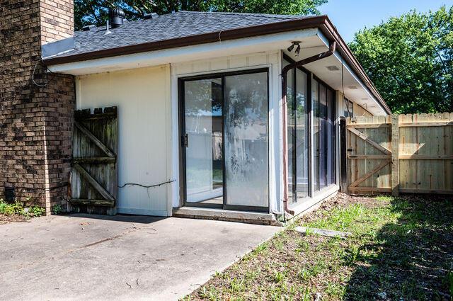 2812 W Maplewood St, Springfield, MO 65807 - doorway to property featuring a gate, a chimney, roof with shingles, and a patio area
