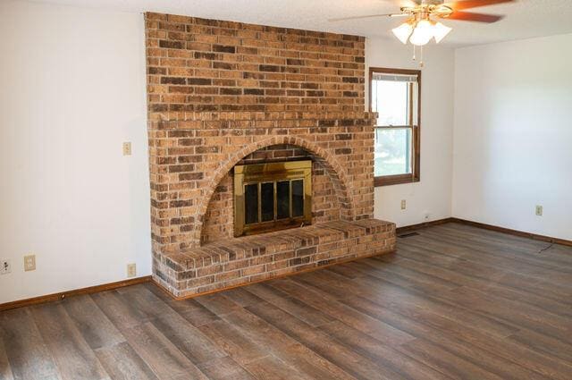2812 W Maplewood St, Springfield, MO 65807 - unfurnished living room with ceiling fan, wood finished floors, and a fireplace