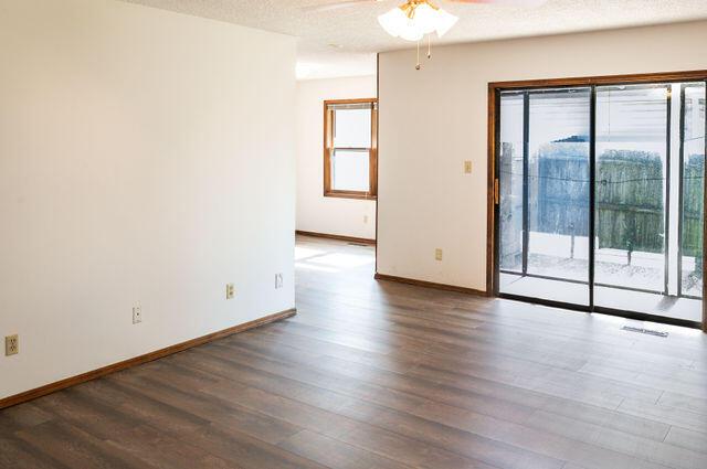 2812 W Maplewood St, Springfield, MO 65807 - empty room featuring a ceiling fan and wood finished floors