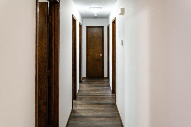2812 W Maplewood St, Springfield, MO 65807 - hall with dark wood-type flooring and a textured ceiling