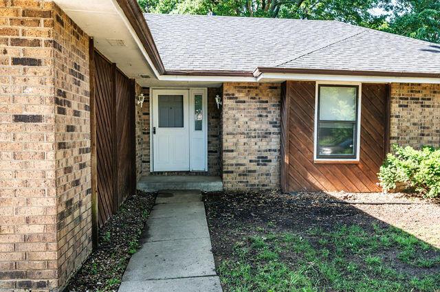 2812 W Maplewood St, Springfield, MO 65807 - view of exterior entry featuring a shingled roof and brick siding