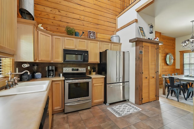 109 Grand Mountain Ave Unit 39-1, Branson, MO 65616 - kitchen featuring stainless steel appliances, wooden walls, light countertops, tasteful backsplash, and a chandelier