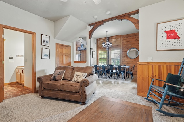 109 Grand Mountain Ave Unit 39-1, Branson, MO 65616 - living room with light carpet, a chandelier, wooden walls, a ceiling fan, and a wainscoted wall