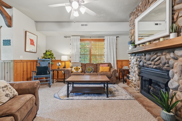 109 Grand Mountain Ave Unit 39-1, Branson, MO 65616 - living area with wainscoting, carpet flooring, ceiling fan, wood walls, and a stone fireplace