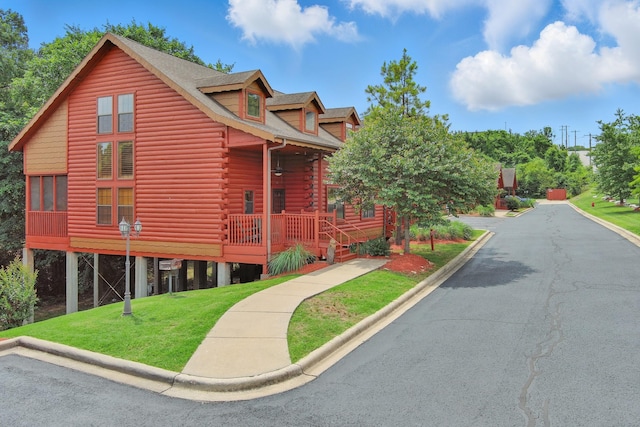109 Grand Mountain Ave Unit 39-1, Branson, MO 65616 - view of front facade with log exterior, a front lawn, and covered porch