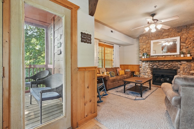 109 Grand Mountain Ave Unit 39-1, Branson, MO 65616 - living area featuring wainscoting, a ceiling fan, a fireplace, wood finished floors, and wood walls
