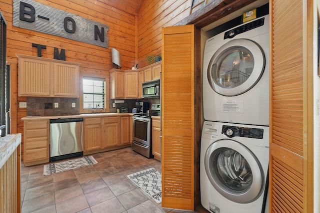 109 Grand Mountain Ave Unit 39-1, Branson, MO 65616 - washroom with stacked washer / dryer and wood walls