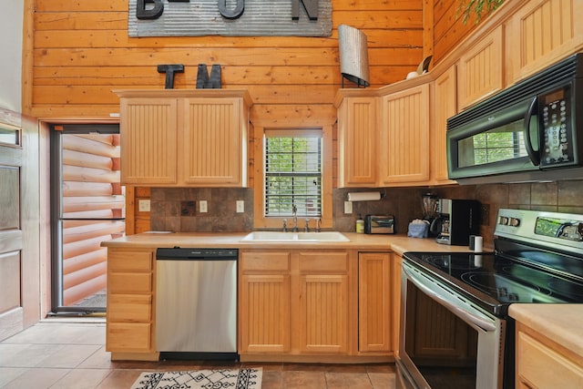 109 Grand Mountain Ave Unit 39-1, Branson, MO 65616 - kitchen with appliances with stainless steel finishes, light brown cabinets, light countertops, backsplash, and wooden walls