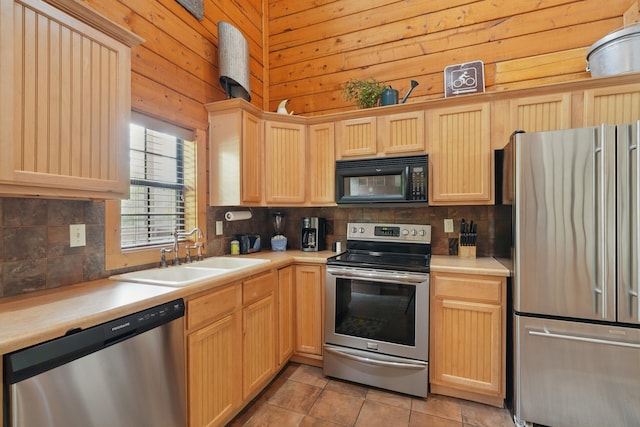 109 Grand Mountain Ave Unit 39-1, Branson, MO 65616 - kitchen with appliances with stainless steel finishes, backsplash, light brown cabinets, light countertops, and wooden walls