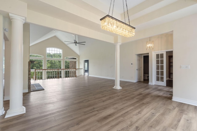 1007 Silvercrest Pl, Reeds Spring, MO 65737 - unfurnished living room with decorative columns, high vaulted ceiling, a ceiling fan, wood finished floors, and a chandelier