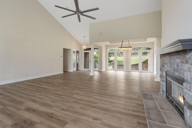 1007 Silvercrest Pl, Reeds Spring, MO 65737 - unfurnished living room featuring high vaulted ceiling, a fireplace, ceiling fan, wood finished floors, and decorative columns
