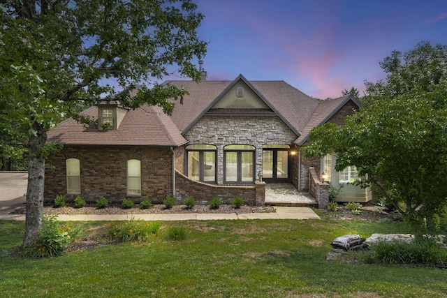 1007 Silvercrest Pl, Reeds Spring, MO 65737 - french country style house with a front lawn, a chimney, and stone siding
